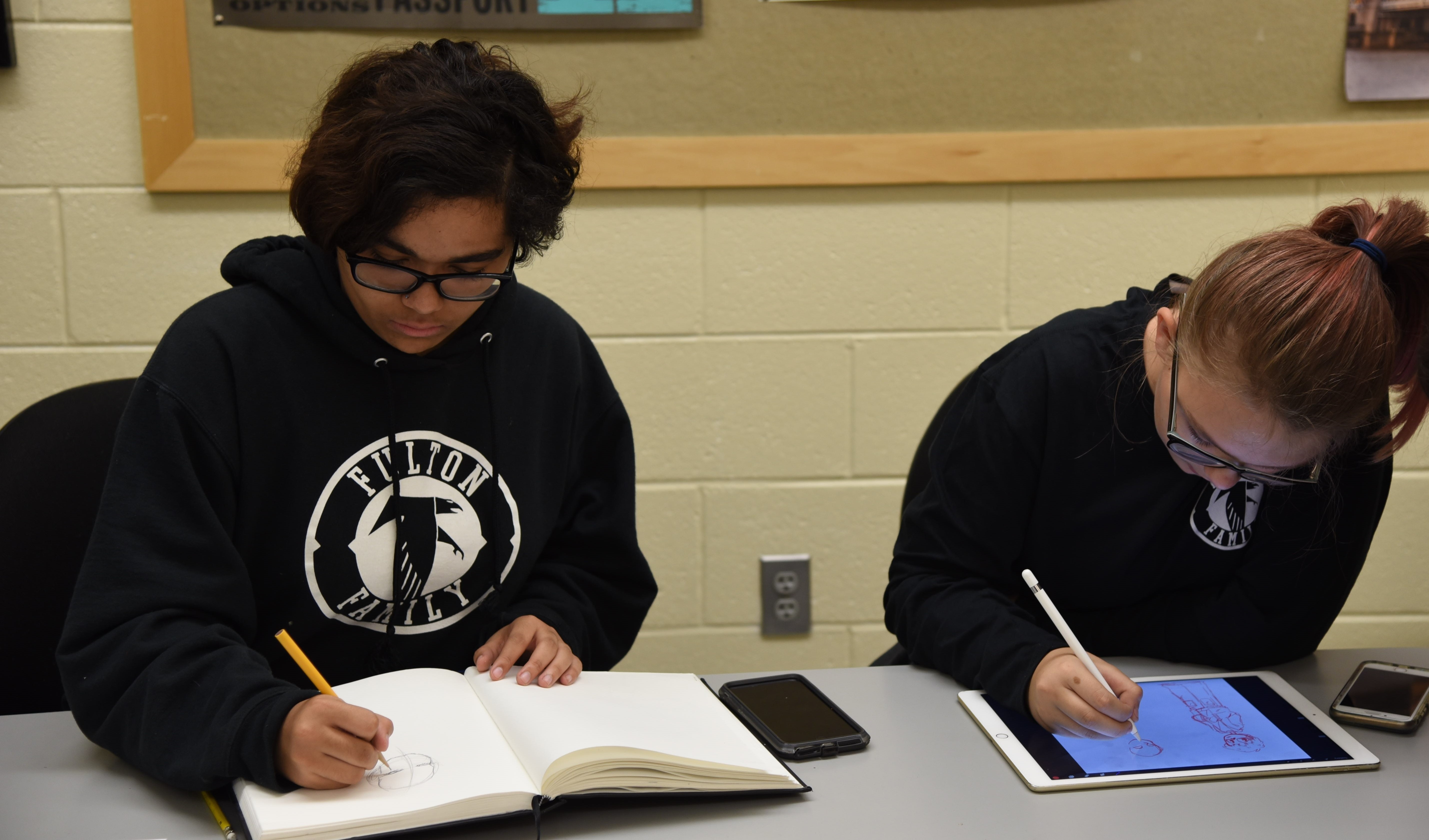 Iyana Jones, left, creative director of the Fulton Comics and Manga Club, and Aletheia “Allie” Cullimore, the club's art director, work on illustrations during a club meeting. 